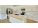 Modern kitchen with white cabinets and large island at 176 Flag Lilly Ln, Umatilla, FL 32784