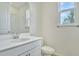 Clean bathroom with white vanity, toilet and shower/tub combo at 176 Flag Lilly Ln, Umatilla, FL 32784