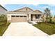 One-story home with stone accents and two-car garage at 176 Flag Lilly Ln, Umatilla, FL 32784