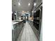 Open kitchen boasts stainless steel appliances, gray cabinets, and an island at 12351 Northover Loop, Orlando, FL 32824