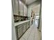 Butlers pantry with grey shaker cabinets, quartz countertops, and tile backsplash at 12351 Northover Loop, Orlando, FL 32824