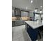 Modern kitchen with a large island, quartz countertops, and stainless steel appliances at 12351 Northover Loop, Orlando, FL 32824