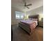 Spacious main bedroom with plush bedding and a ceiling fan at 12351 Northover Loop, Orlando, FL 32824