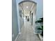 Long hallway with tile floors and access to the living room at 12351 Northover Loop, Orlando, FL 32824