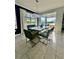 Bright dining room with large window, modern chandelier, and seating for six at 12351 Northover Loop, Orlando, FL 32824