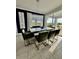 Modern dining room with large window, chandelier, and gray seating for six at 12351 Northover Loop, Orlando, FL 32824