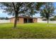 Large backyard with home and screened patio at 840 Crooked Branch Dr, Clermont, FL 34711