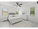 Bright bedroom with a white bed frame, dresser, and window coverings at 840 Crooked Branch Dr, Clermont, FL 34711