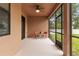 Cozy screened porch with small table and chairs at 840 Crooked Branch Dr, Clermont, FL 34711