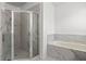 Clean bathroom with a walk-in shower and marble tile at 840 Crooked Branch Dr, Clermont, FL 34711