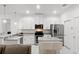Modern kitchen with white cabinets, stainless steel appliances, and granite countertops at 840 Crooked Branch Dr, Clermont, FL 34711