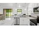 Modern kitchen with white cabinets, stainless steel appliances and granite countertops at 840 Crooked Branch Dr, Clermont, FL 34711