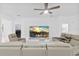 Living room with large sectional sofa and a large TV at 840 Crooked Branch Dr, Clermont, FL 34711