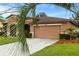 One-story house with a two-car garage and palm trees at 840 Crooked Branch Dr, Clermont, FL 34711