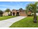 One-story house with a two-car garage and palm trees at 840 Crooked Branch Dr, Clermont, FL 34711