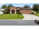 One-story house with a two-car garage and palm trees at 840 Crooked Branch Dr, Clermont, FL 34711