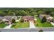Aerial view of a single-Gathering home with a well-manicured lawn and surrounding houses at 840 Crooked Branch Dr, Clermont, FL 34711