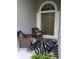 Inviting entryway with two wicker chairs and decorative rug at 3601 Daydream Pl, Saint Cloud, FL 34772