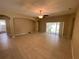 Spacious living room with tile floors and access to backyard at 3601 Daydream Pl, Saint Cloud, FL 34772