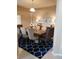 Bright dining room features a large table with seating for eight and stylish area rug at 3601 Daydream Pl, Saint Cloud, FL 34772