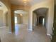 Spacious foyer with tile floors and arched hallways at 3601 Daydream Pl, Saint Cloud, FL 34772