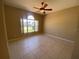 Sunlit living room with large window and tile flooring at 3601 Daydream Pl, Saint Cloud, FL 34772