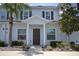 Two-story home with brown door and landscaping at 3208 Cupid Pl, Kissimmee, FL 34747