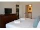 King bed, dresser, and ensuite bathroom access at 3208 Cupid Pl, Kissimmee, FL 34747