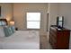 King size bed, dresser and large window in bright bedroom at 3208 Cupid Pl, Kissimmee, FL 34747