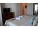 King bed, dresser, and ensuite bathroom access at 3208 Cupid Pl, Kissimmee, FL 34747
