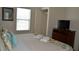 Comfortable bedroom with a king-size bed, dresser, and large window at 3208 Cupid Pl, Kissimmee, FL 34747
