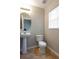 Bathroom with pedestal sink, toilet and tile flooring at 2480 Hassonite St, Kissimmee, FL 34744