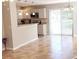 Open kitchen with breakfast bar, stainless steel appliances, and tile flooring at 2480 Hassonite St, Kissimmee, FL 34744
