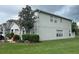Gray two-story house with landscaping and a large tree at 2480 Hassonite St, Kissimmee, FL 34744
