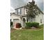Two story house with gray exterior, landscaping, and red flowers at 2480 Hassonite St, Kissimmee, FL 34744