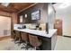 Kitchen boasts a breakfast bar with brown vinyl stools and dark wood cabinets at 950 S Narcoossee Rd, St Cloud, FL 34771