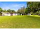 Single story home with multiple outbuildings and a large yard at 950 S Narcoossee Rd, St Cloud, FL 34771