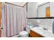 Bathroom with shower, toilet, and wooden vanity at 950 S Narcoossee Rd, St Cloud, FL 34771