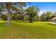 Large backyard with lush green grass and mature oak trees at 950 S Narcoossee Rd, St Cloud, FL 34771