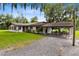 Ranch-style home with covered patio and ample parking at 950 S Narcoossee Rd, St Cloud, FL 34771