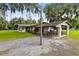 House exterior showcasing a covered patio and spacious backyard at 950 S Narcoossee Rd, St Cloud, FL 34771