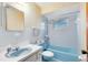 Bathroom with light blue bathtub, sink, and toilet at 950 S Narcoossee Rd, St Cloud, FL 34771