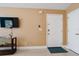 Bright and airy entryway with a flat-screen TV and neutral color scheme at 5012 Laguna Bay Cir # 74, Kissimmee, FL 34746