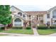 Front view of charming two-story condo with landscaping at 5012 Laguna Bay Cir # 74, Kissimmee, FL 34746