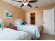 Twin bedroom with ceiling fan and nautical-themed bedding at 5012 Laguna Bay Cir # 74, Kissimmee, FL 34746