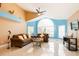 Open living room with vaulted ceiling, two sofas, and large window for abundant light at 5012 Laguna Bay Cir # 74, Kissimmee, FL 34746