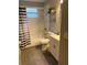 Clean bathroom with a shower/tub combo, vanity, and updated fixtures at 8713 Sw Rockingham Ter # D, Kissimmee, FL 34747