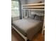 Spacious bedroom with a queen bed, a bunk bed, and ample closet space at 8713 Sw Rockingham Ter # D, Kissimmee, FL 34747