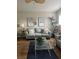 Living room with gray couch, coffee table, and decorative wall art at 8713 Sw Rockingham Ter # D, Kissimmee, FL 34747