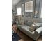 Living room featuring a gray couch, decorative pillows, and wall art at 8713 Sw Rockingham Ter # D, Kissimmee, FL 34747